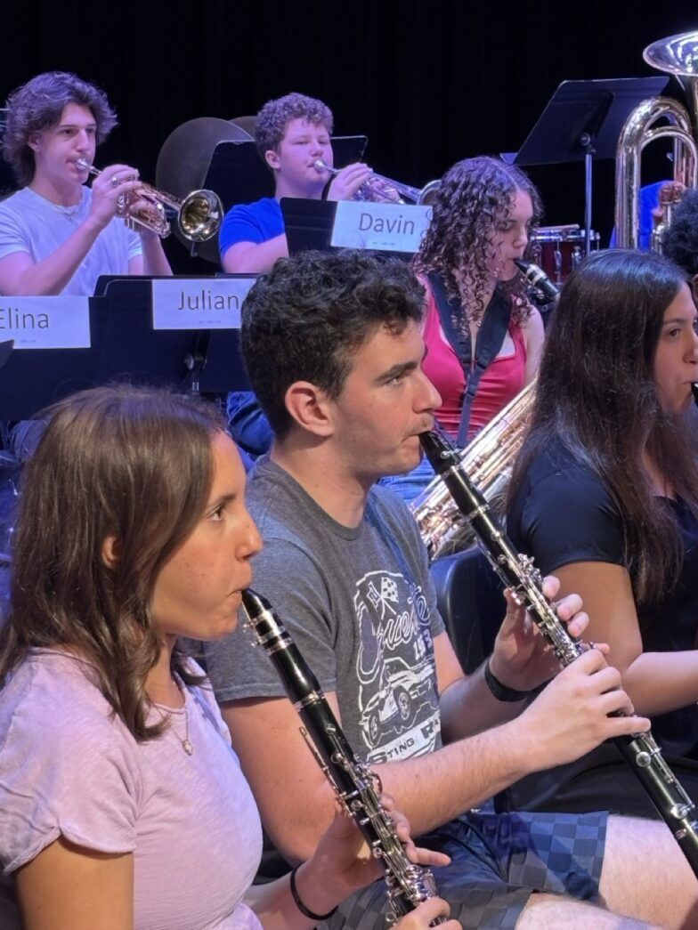 a group of people playing instruments in front of a crowd