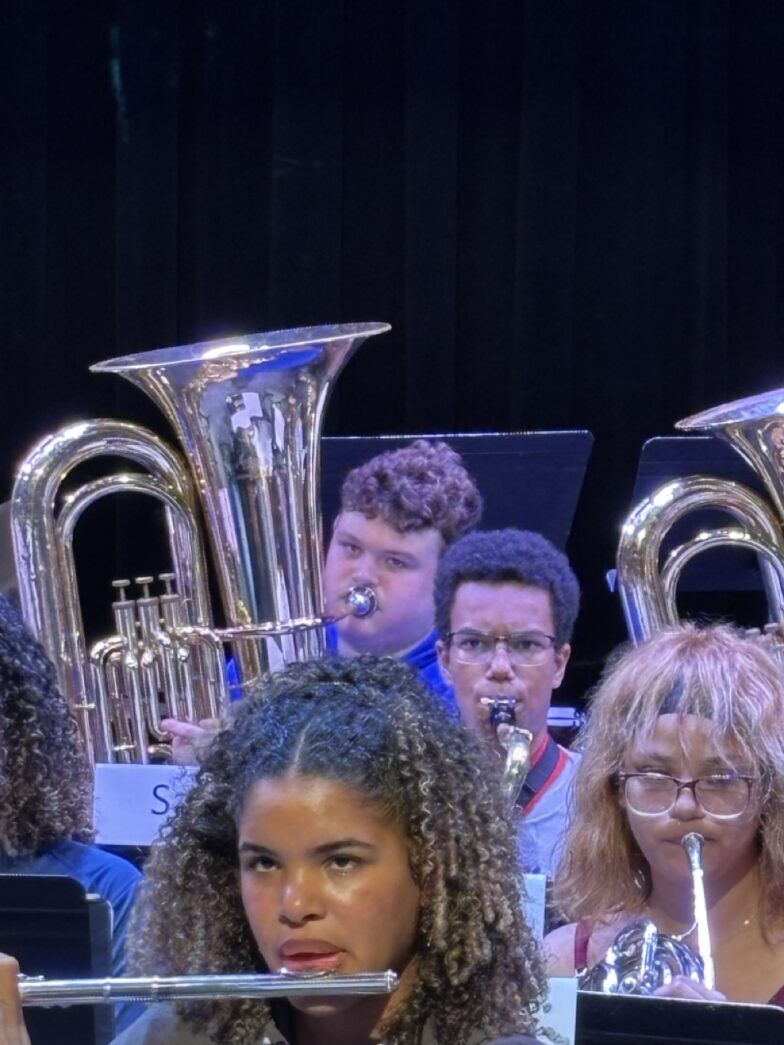 a group of people playing musical instruments on a stage