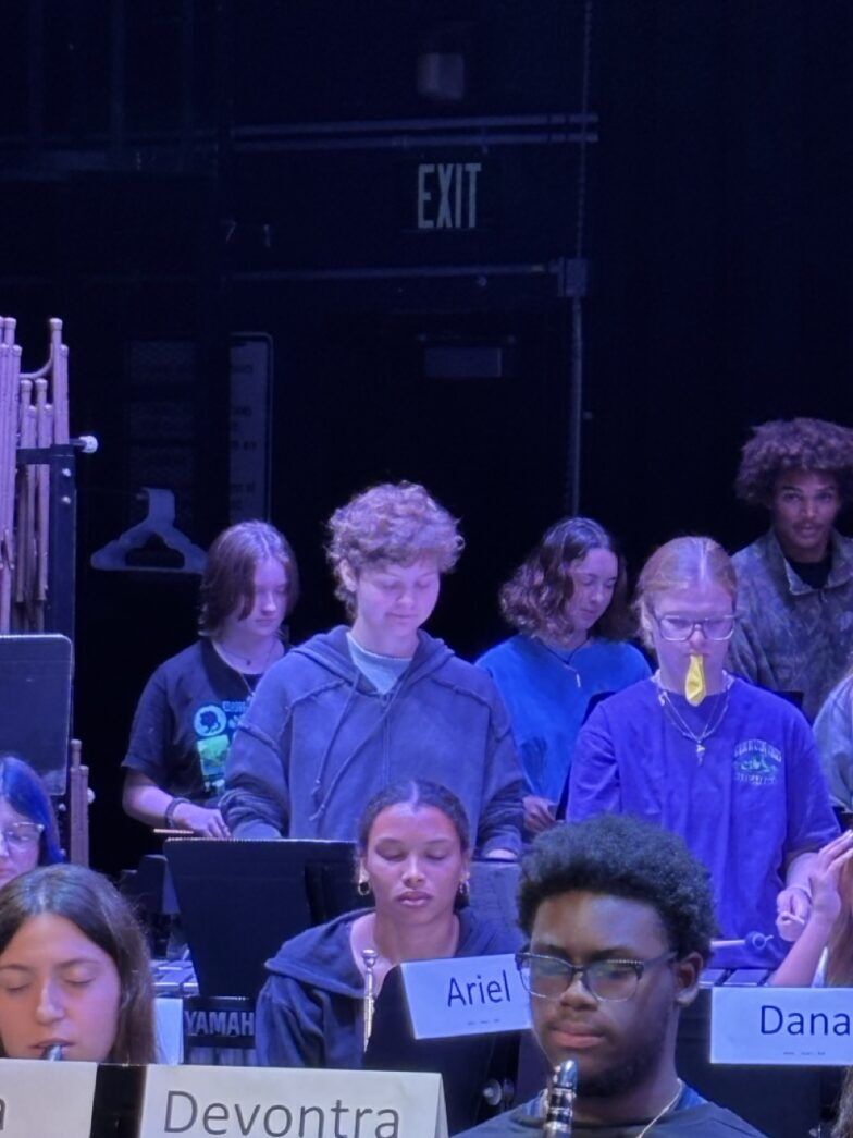 a group of people sitting in front of a microphone