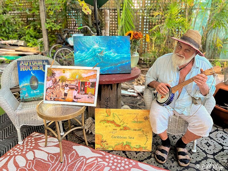 a man sitting on a chair playing a guitar