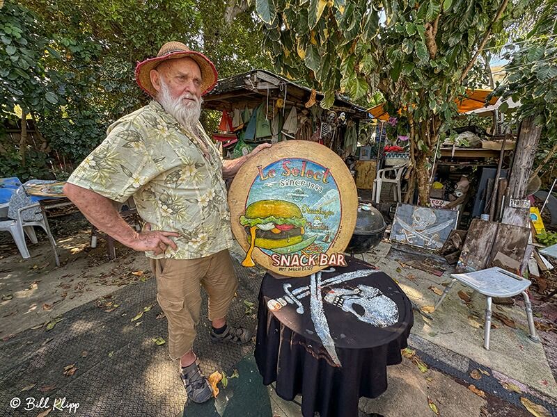 a man standing in front of a sign