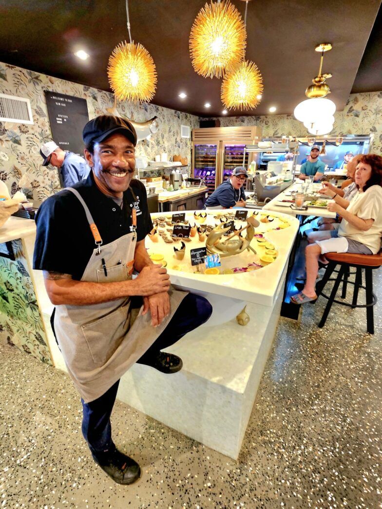 a man sitting at a counter in a restaurant