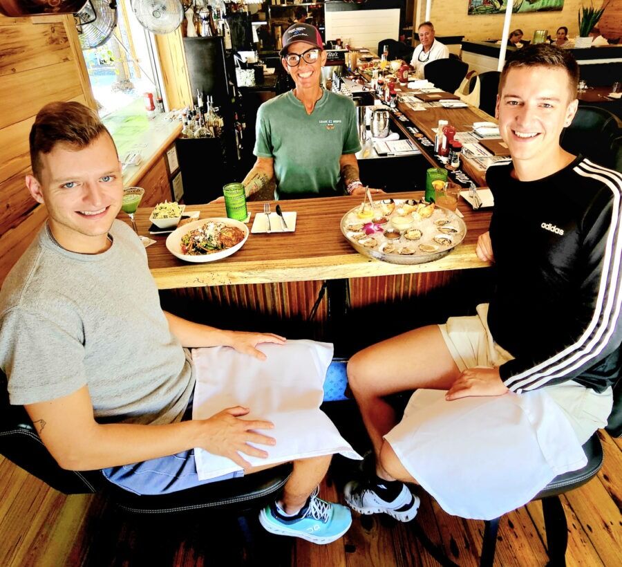 a couple of men sitting at a table in a restaurant