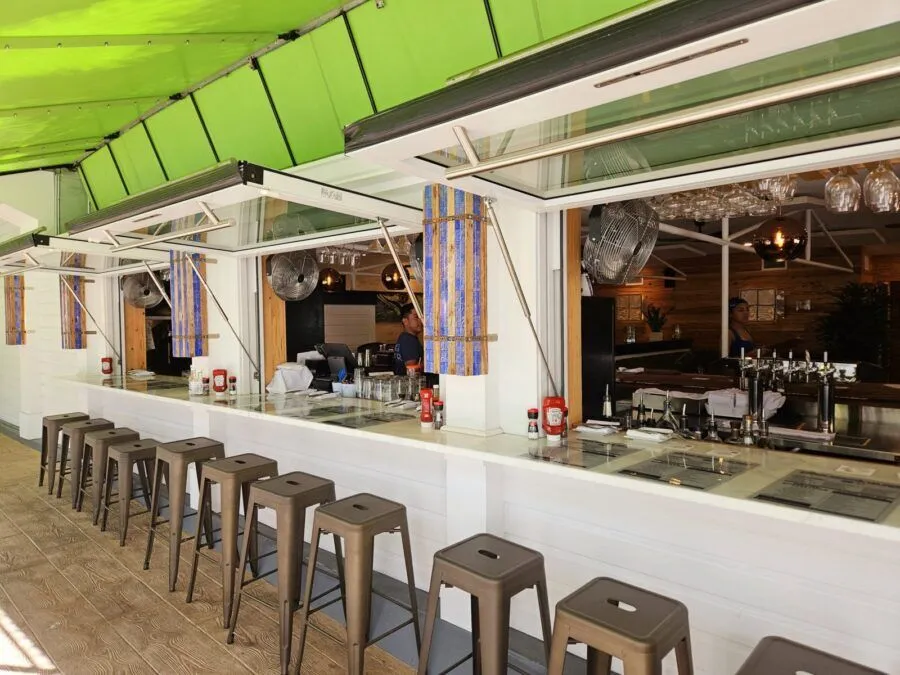 a long bar with stools in front of it