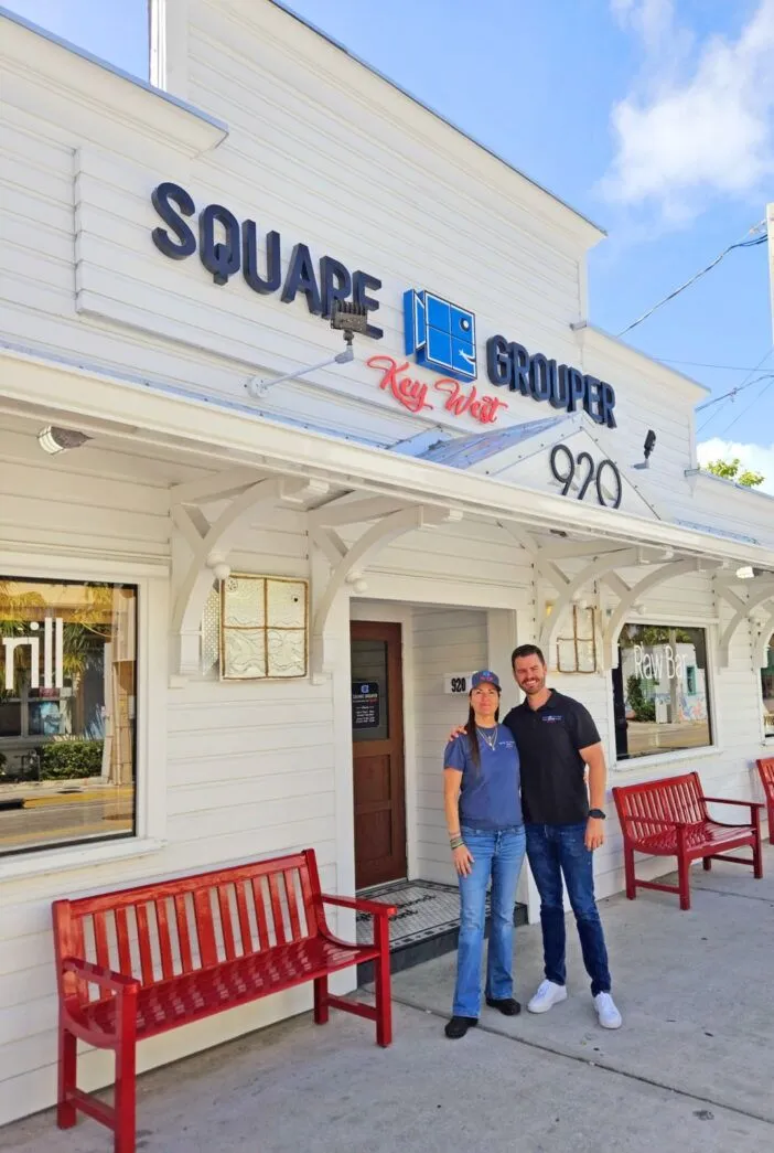 a couple of men standing outside of a building