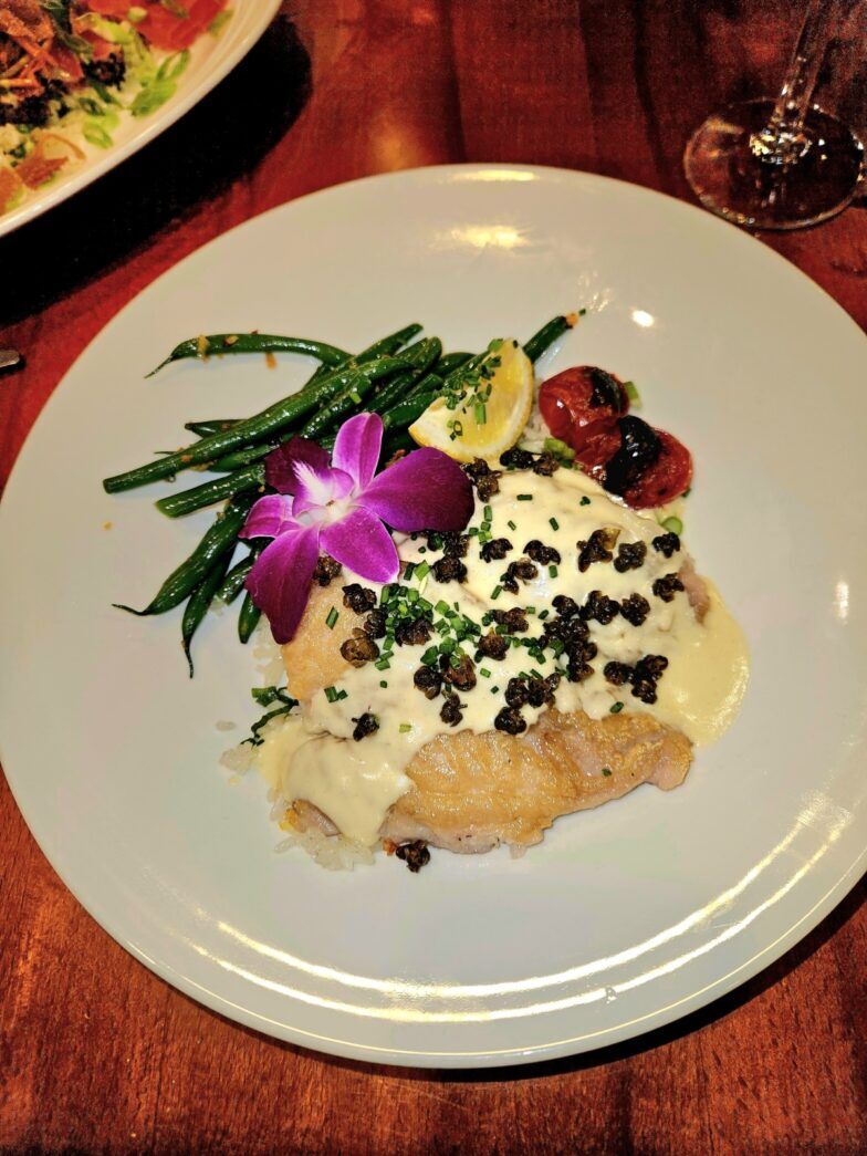 a white plate topped with food on top of a wooden table