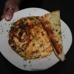 A plate of food with a slice of pizza - Breakfast