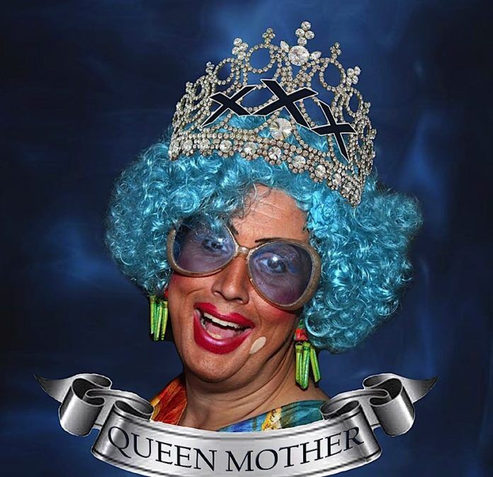 0509_queenmother web A smiling man wearing a hat and sunglasses - Headpiece