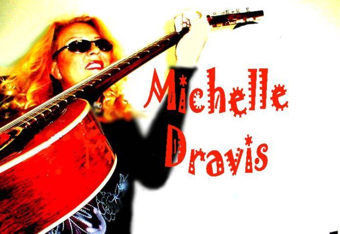 Bandside #Events: Michelle Dravis can play every style - A person holding a guitar - Bass guitar