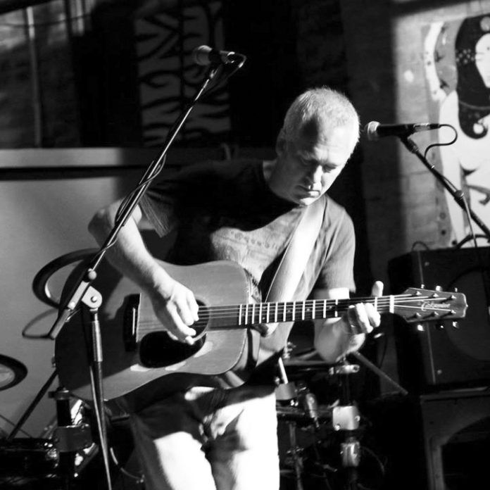#Music: An acoustic performer with traditional roots - A man holding a guitar - Bass guitar