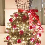 #SeenAroundTown: Festival of Tree culminates in Gala - A vase of flowers on a table next to a christmas tree - Christmas tree