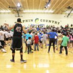 Fantastic Finatics crush professional team* - A group of people standing in a room - Basketball