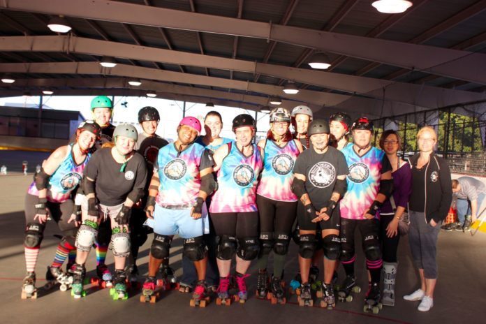 Fall seven times, stand up eight - A group of people posing for the camera - Roller derby