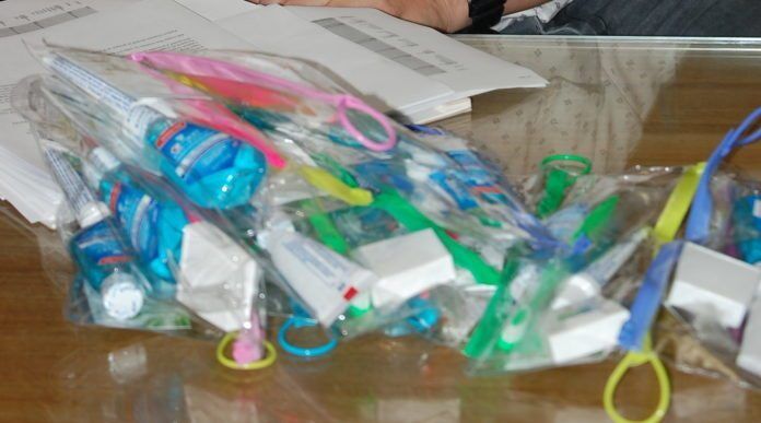 1014ukdental Dental care rolls through the Upper Keys - A cluttered desk with a laptop computer sitting on top of a table - Plastic