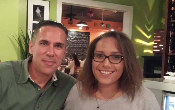Remembering Manny Madruga - A smiling man and woman posing for a photo - Glasses