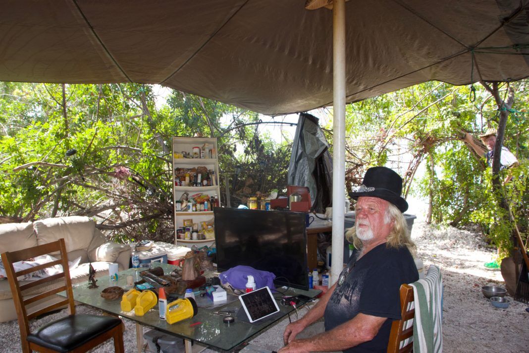 0916Wisteria Island2 Wisteria Island: It’s complicated - A person sitting at a table - Wisteria Island