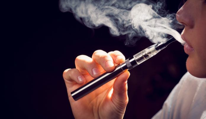 0503vaping Proud landmark now a shambles - A close up of a person holding a cell phone - Tobacco smoking