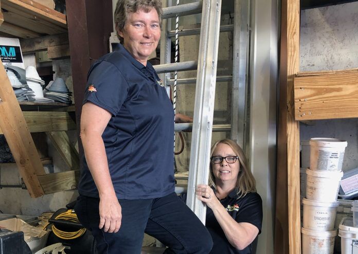 job Meet the women of Keys All Area Roofing - A man and a woman standing in front of a building - Job