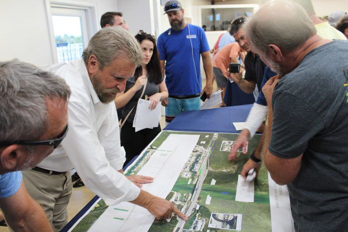 Snake Creek bridge at MM 85 Residents give input on Snake Creek bridge - A group of people standing around a table - Islamorada