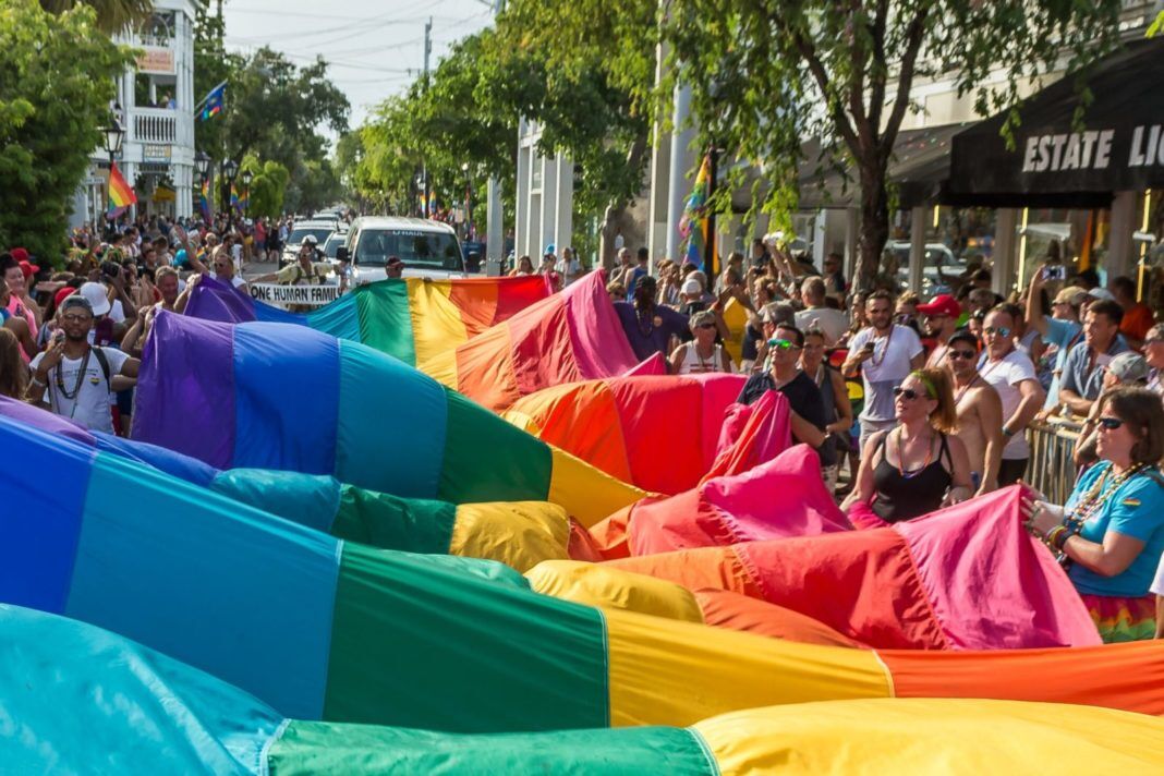 PrideFlag Rainbows in Forecast for Key West - A crowd of people watching a colorful blanket - Key West
