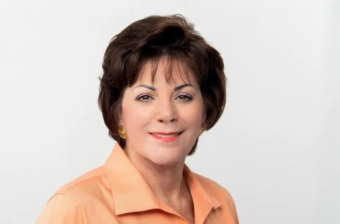 Virginia Panico Announces Retirement – Key West Chamber Head Steps Down in December - A woman wearing a white shirt and smiling at the camera - Florida Keys