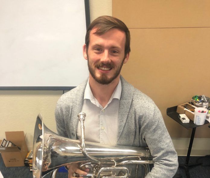 MMHS band director has sights set on growth - A man smiling for the camera - Baritone saxophone