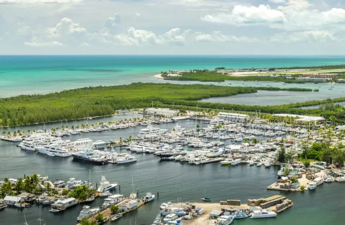 AerialSIMV It takes a village… - A small boat in a body of water - Marina