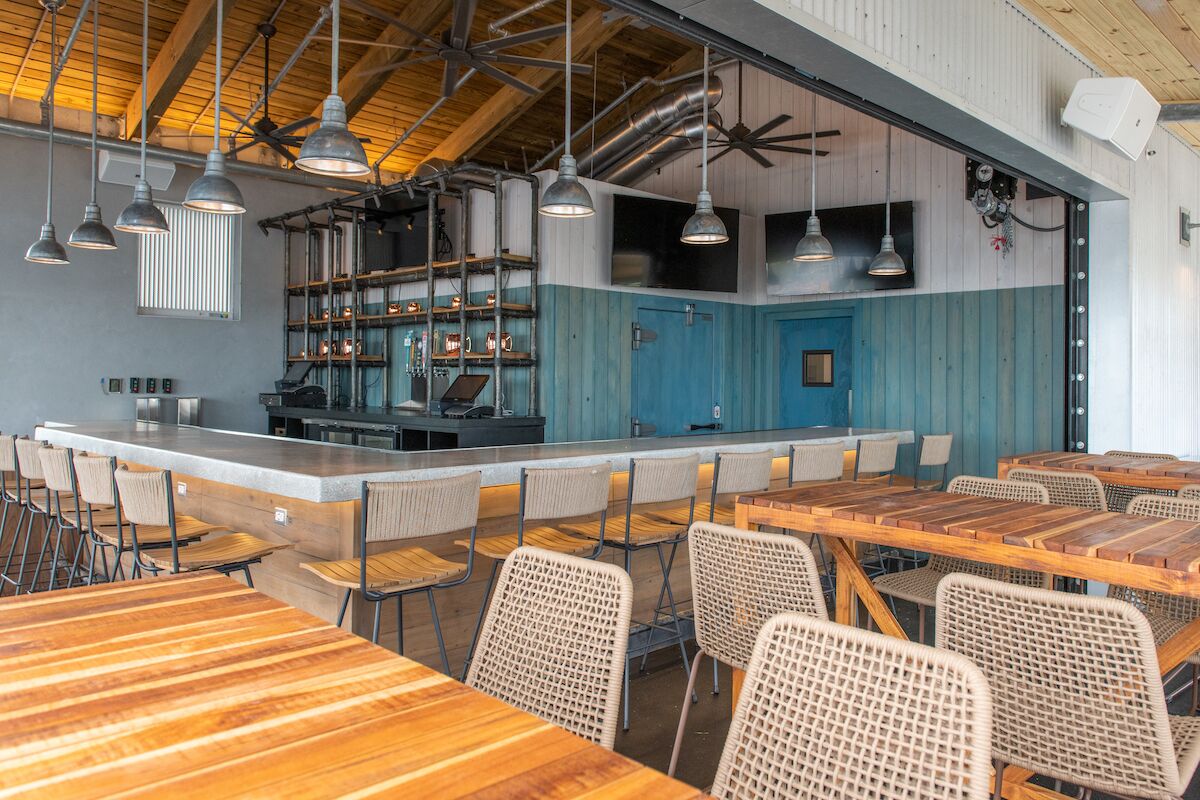 It takes a village… - A dining room table in front of a building - Interior Design Services