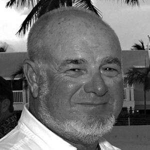 IN MEMORIAM 2019 - A man wearing a suit and tie smiling at the camera - Mel Fisher Maritime Museum