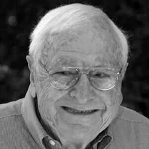 IN MEMORIAM 2019 - A man wearing glasses and smiling at the camera - Forehead