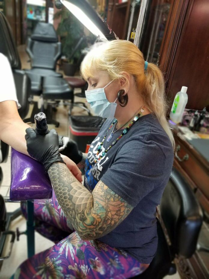 Cassandra Clark tattooing