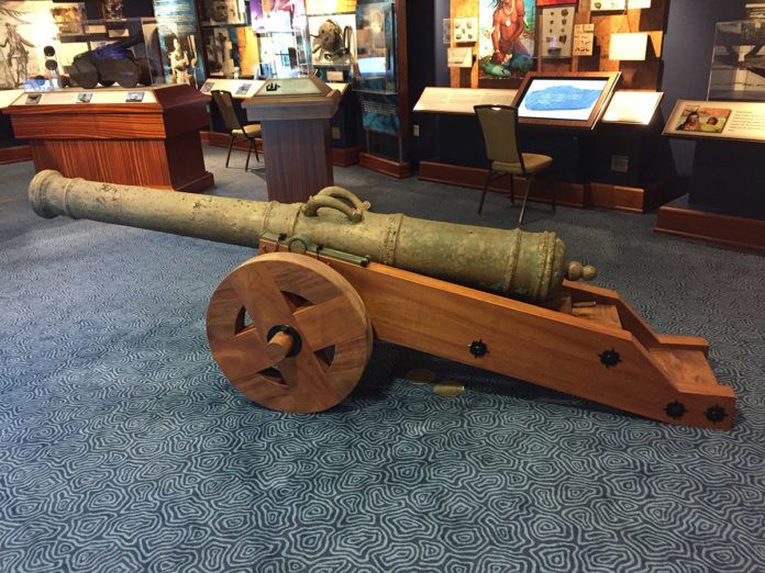 a wooden cannon on display in a museum