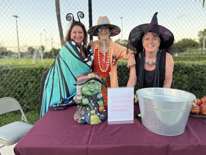 IMG_8178 three women dressed up for halloween sitting at a table