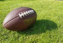 a football sitting on top of a lush green field