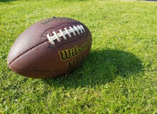 a football sitting on top of a lush green field
