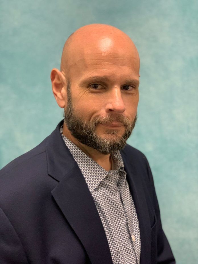 a man with a bald head wearing a suit