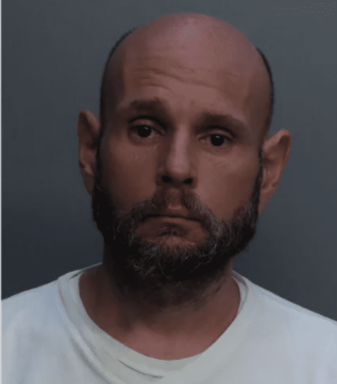 a mug shot of a man with a bald head