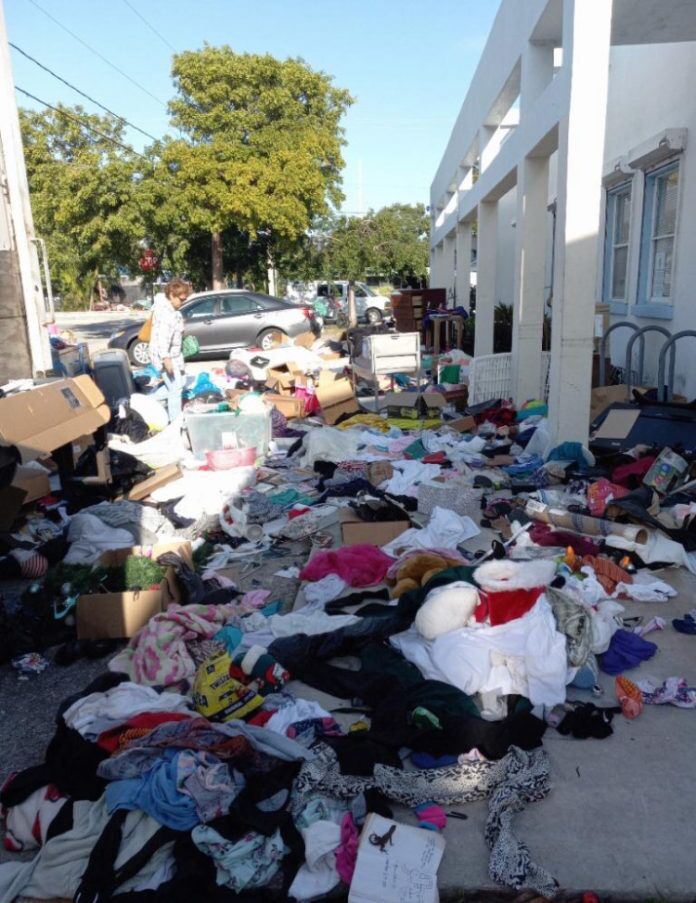 a pile of clothes sitting on the side of a road