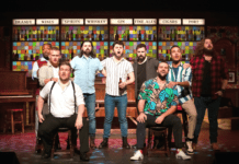 CHOIR OF MAN SINGS, DRINKS, DELIGHTS AT TENNESSEE WILLIAMS THEATRE a group of men standing on top of a stage