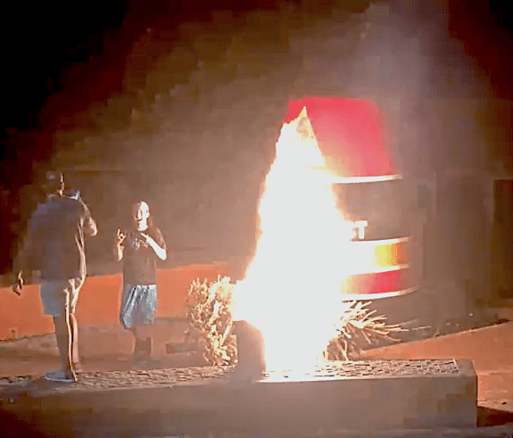 fire from video a couple of people standing next to a fire