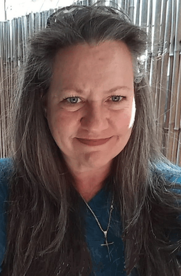 a woman with long hair and a blue shirt
