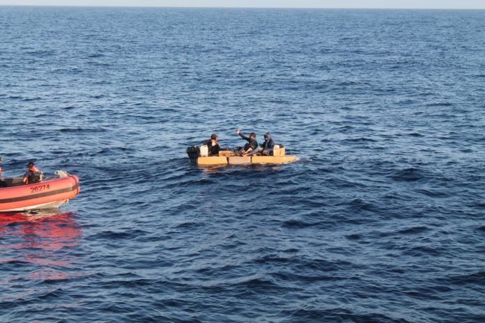a small boat in the middle of a large body of water