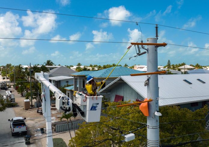 a man on a crane working on a house