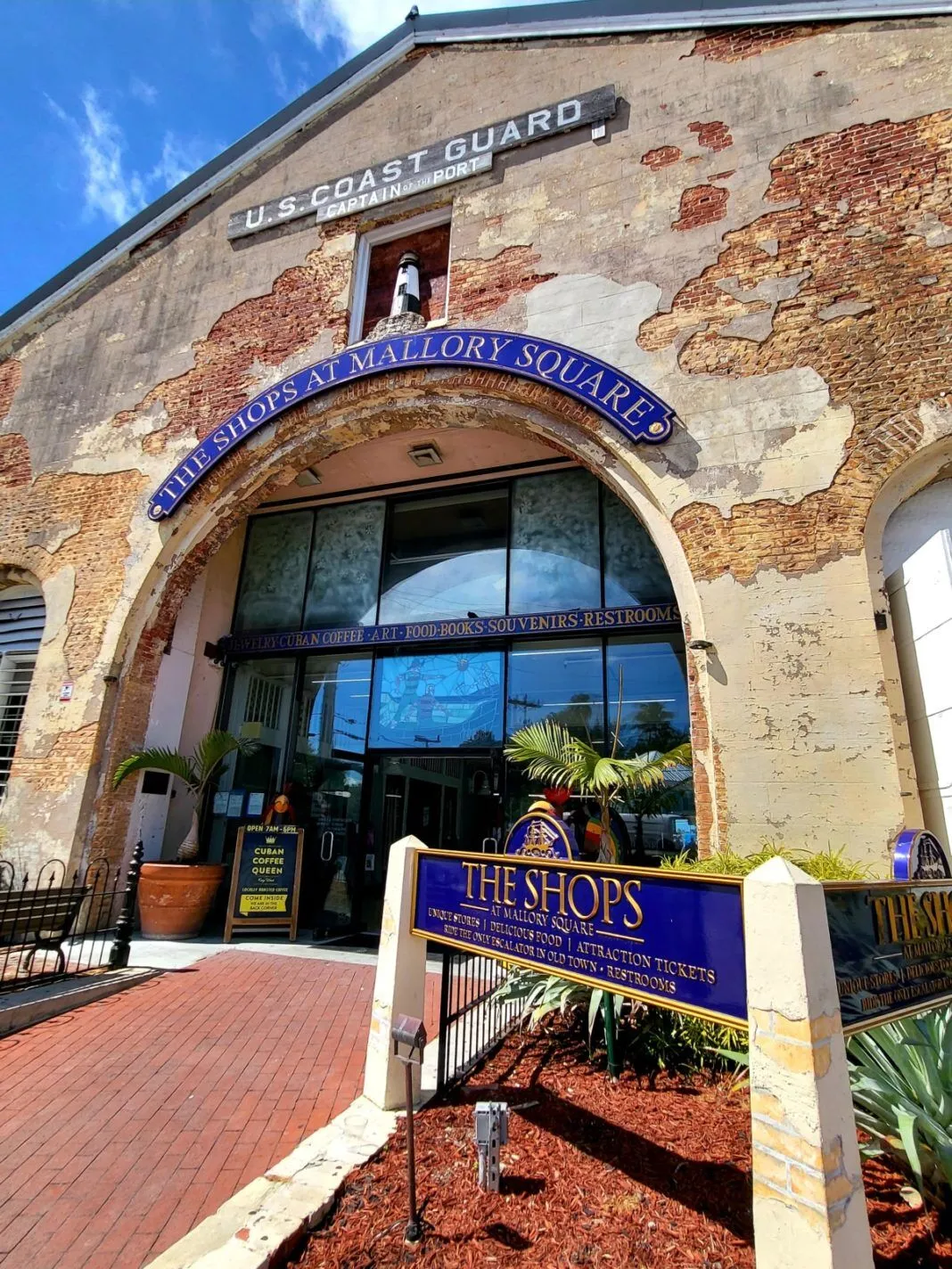 a brick building with a sign in front of it