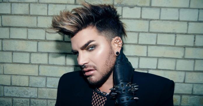 a man in a suit and tie with spiked hair