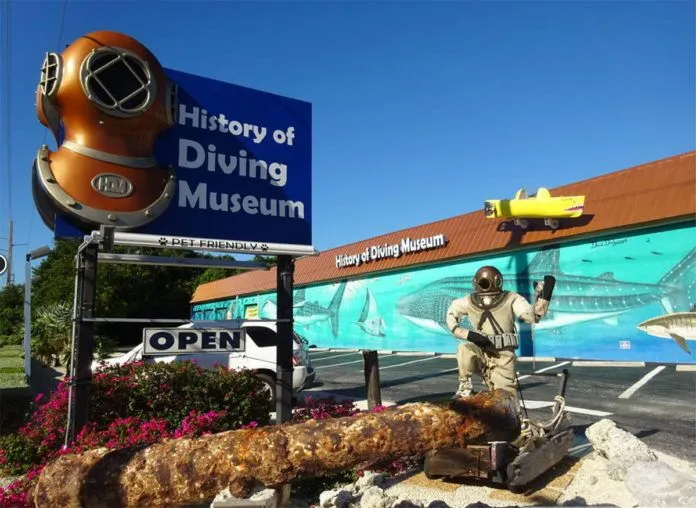 Dive-Museum a man standing in front of a diving museum