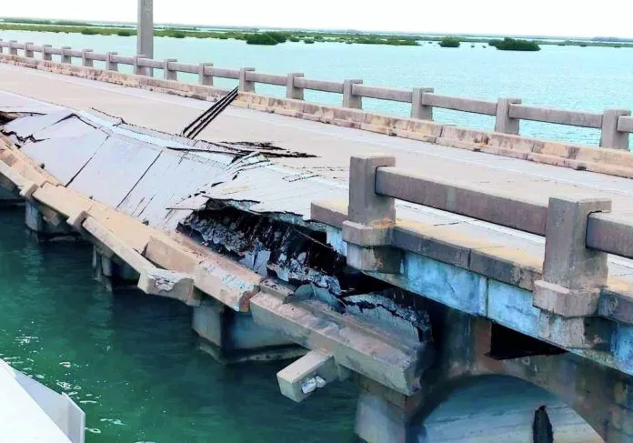 collapse-2 a broken bridge over a body of water