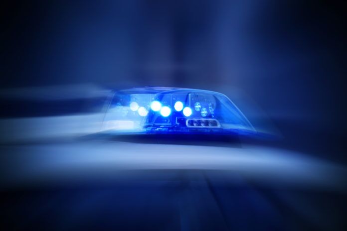 Police,Car,With,Blue,Lights,Switched,On a police car with its lights on in the dark