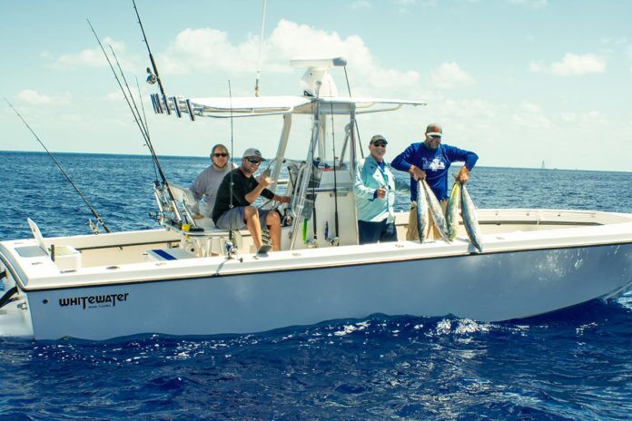 Chris-Mike-6 a group of people on a boat in the ocean