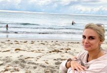 BEHIND THE BLONDE: GOODBYE, MY LOVER — A YEAR WITHOUT BOOZE a woman sitting on a beach next to the ocean